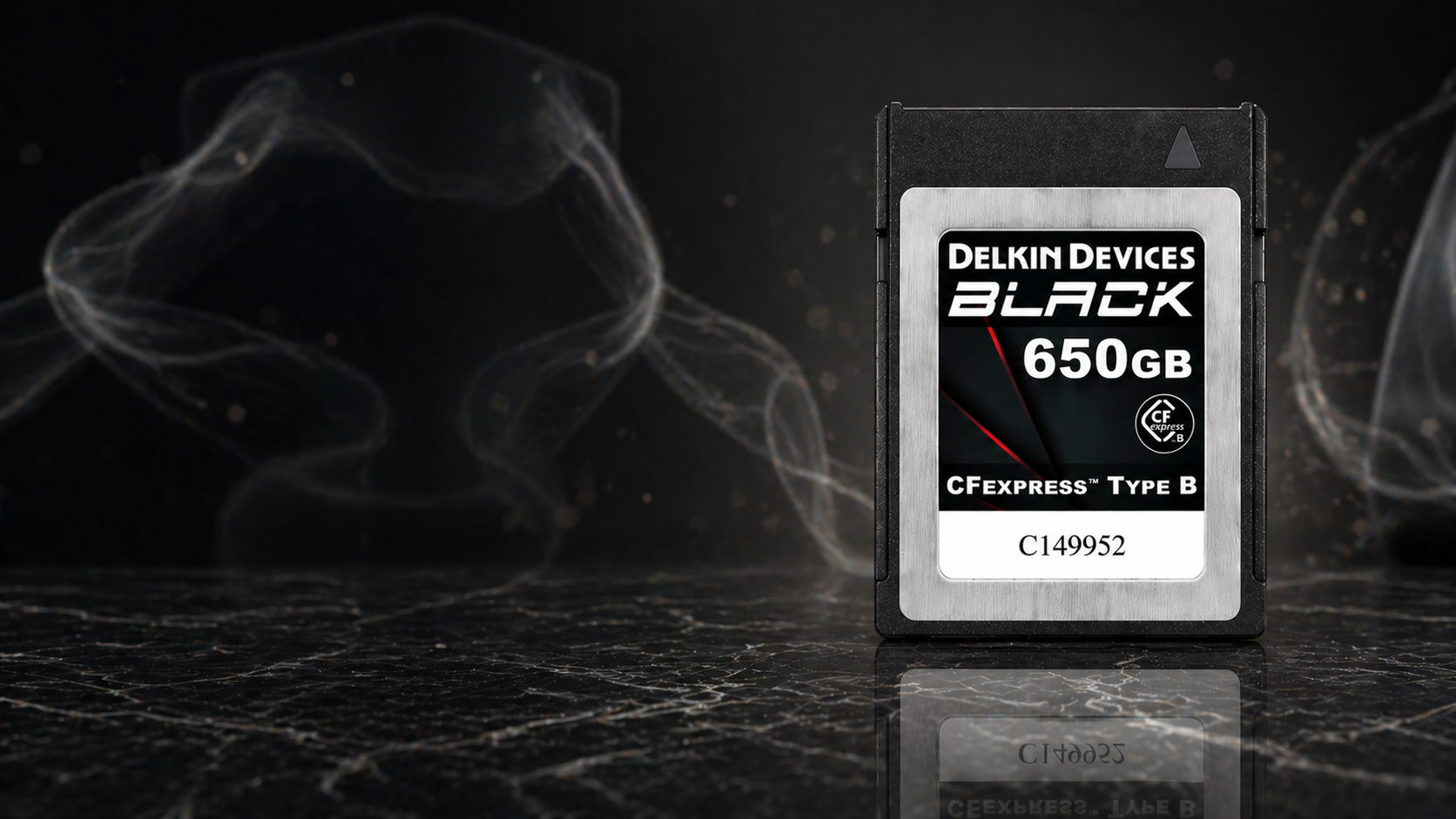 Delkin Devices Black 650GB memory card on a dark background with smoke effects